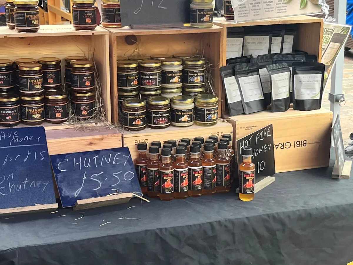 Author Carl honey and food products displayed at a market stall